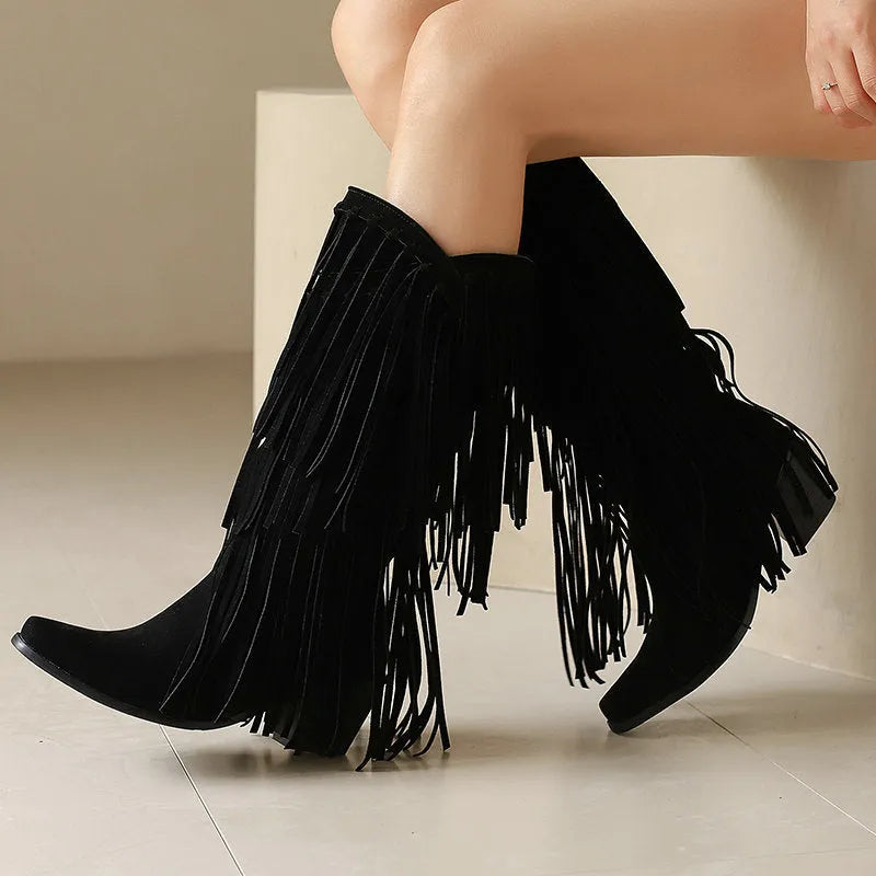 Women's beige suede high boots with tassel detail and a chunky rubber sole.