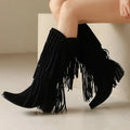 Women's beige suede high boots with tassel detail and a chunky rubber sole.