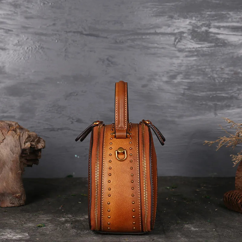 Vintage suede cowhide leather handbag showing interior mobile phone compartment, ID pocket, and laminated zipper pocket