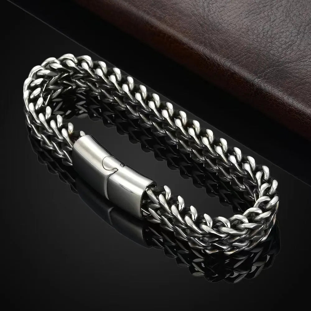 Silver titanium steel men's bracelet with geometric pattern on front and back of links.