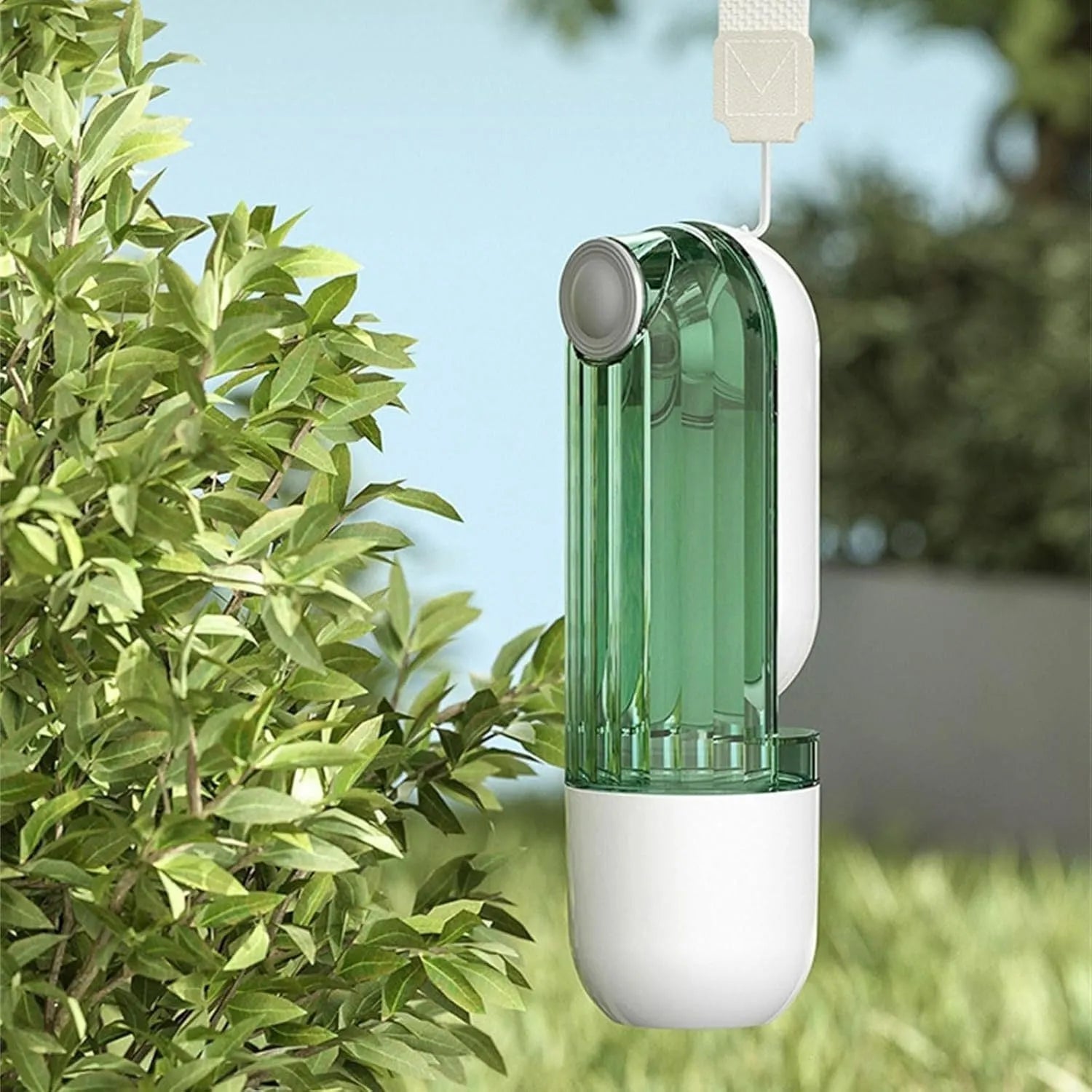 Green foldable dog water bottle with leak-proof lid and food container, shown extended for use.