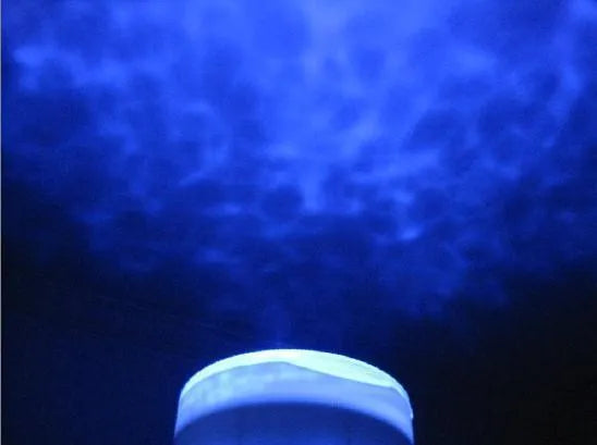 Blue ocean theme LED projection lamp with DLP correction on a surface.