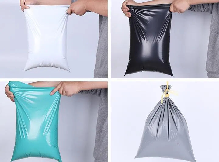 Bundle of 100 clear PE plastic courier clothing bags in multiple sizes with adhesive sticker seals.
