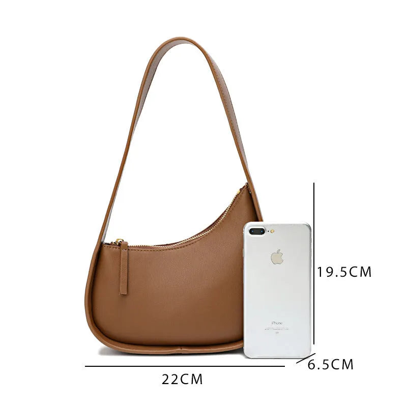 Small brown leather crescent shaped women's shoulder bag with wide strap