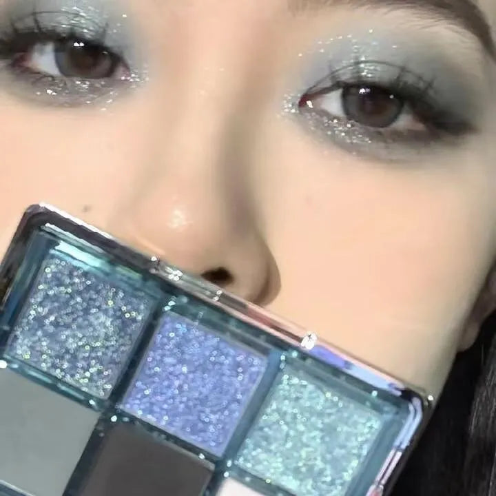 Nine-colour eye shadow palette with blue smoked shades showing matte and shimmer finishes
