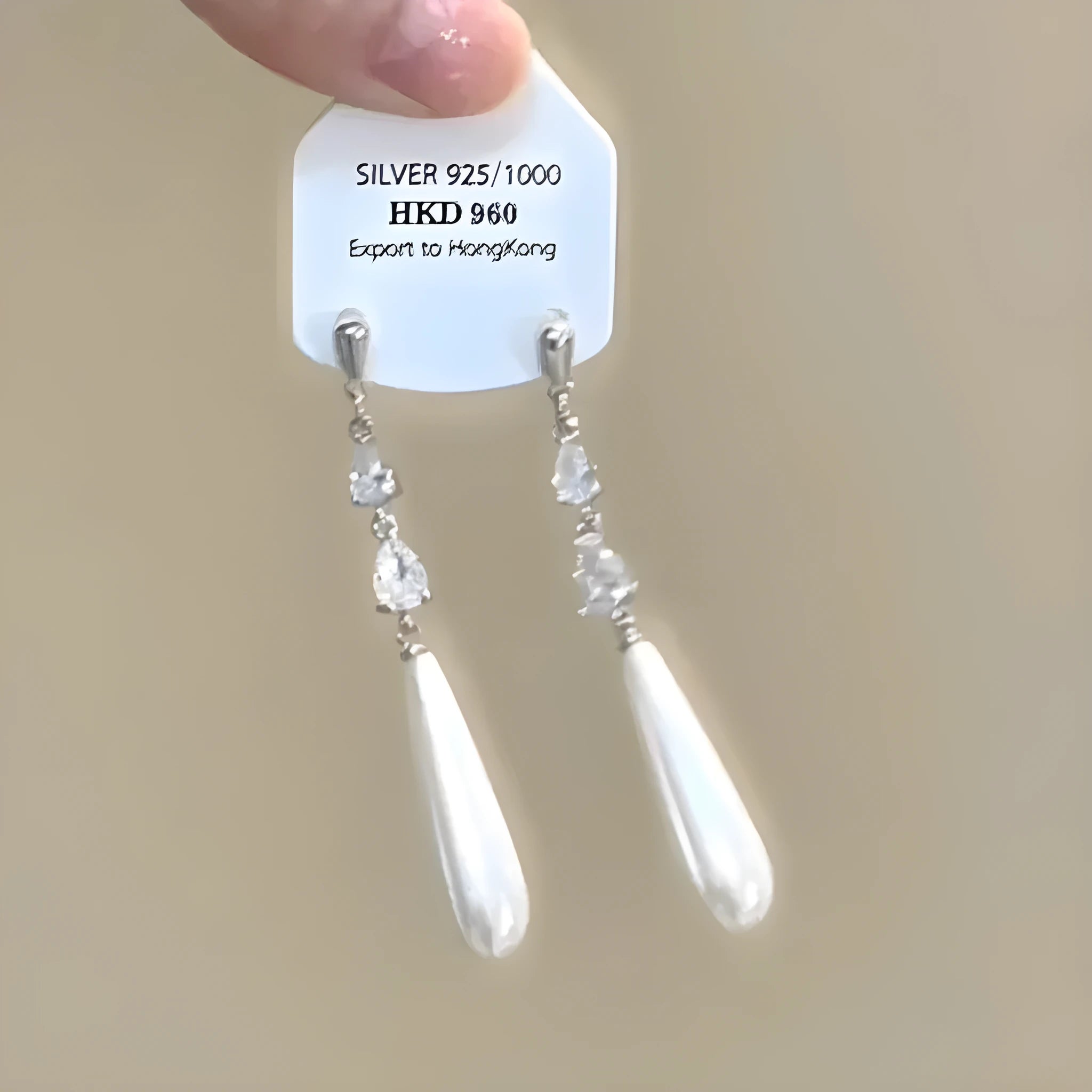 Geometric heart-shaped alloy ear clips with rhinestone accents and dangling star tassels in silver-tone