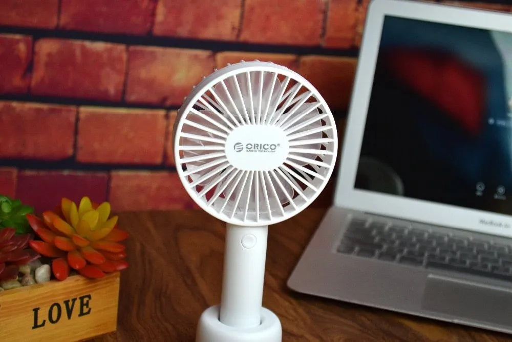 White ORICO FH1 portable USB rechargeable fan with fine line detailing, shown in handheld and desktop positions.
