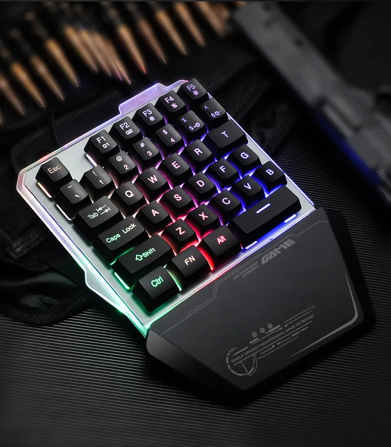 Black G40 Flow Colour one-handed mechanical keyboard with RGB backlit keys on a desk.