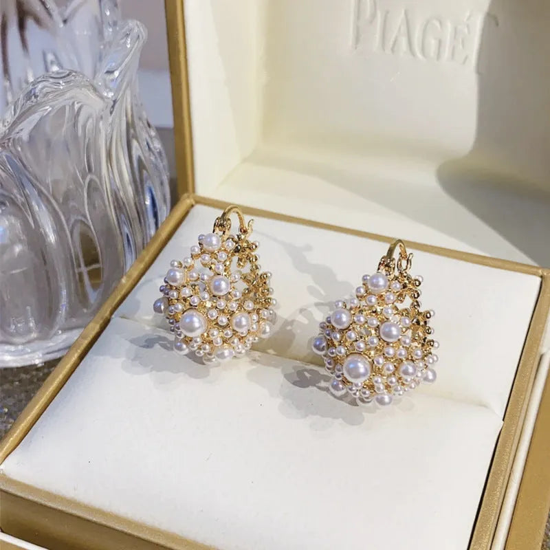 Gold-colour women's flower basket earrings with copper construction and small bead inlay detail.