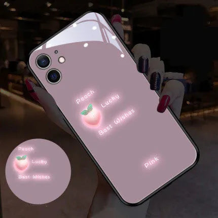 White iPhone case with painted purple daisies and lettering, illuminated with voice-activated colour-changing lights.