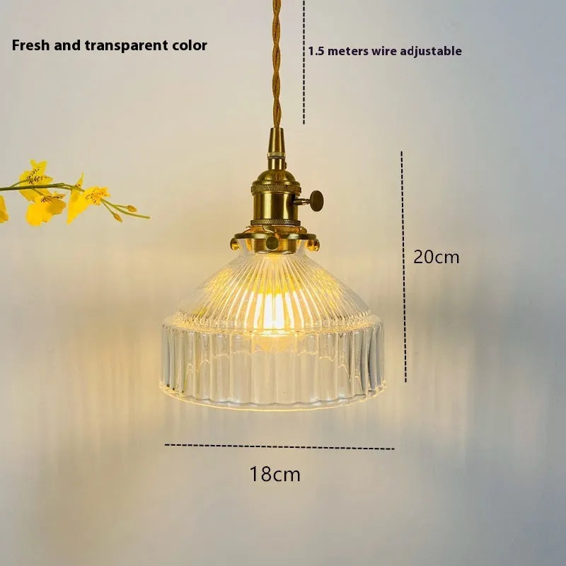 Brass and glass ceiling chandelier light with an adjustable suspension wire.