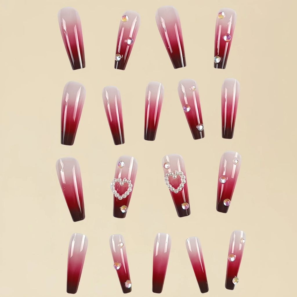 Wine red gradient false nail tips with plaid pattern and pearl heart accents in a long ballet shape.