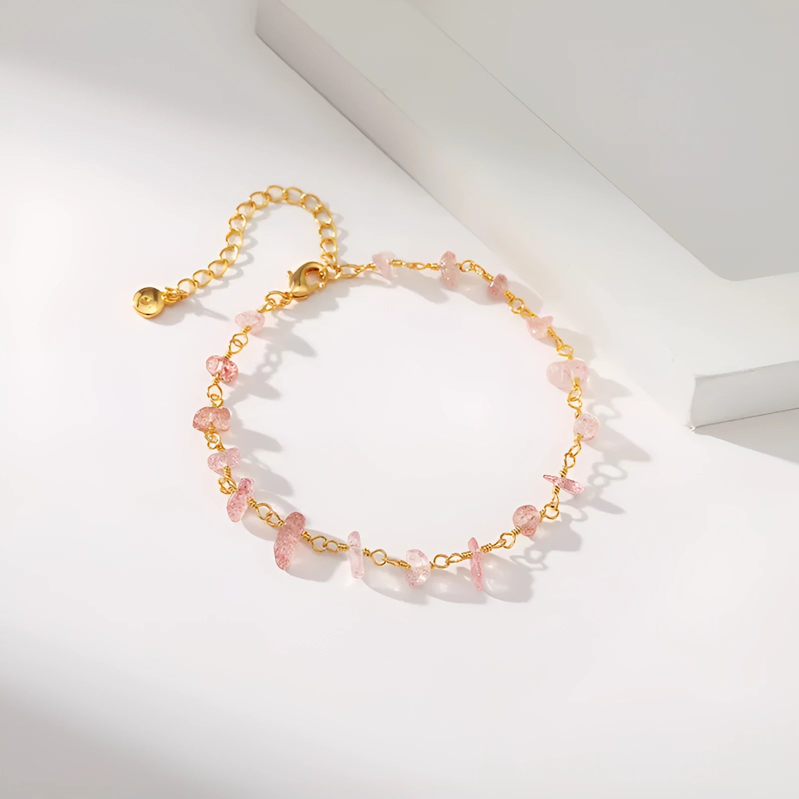 Irregular geometric gravel bracelet with crystal accents in 18K gold plated copper, showing blue colour option