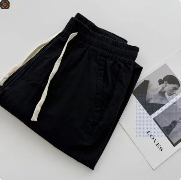Men's loose straight leg casual trousers in beige with a drawstring waist and elasticated ankles.