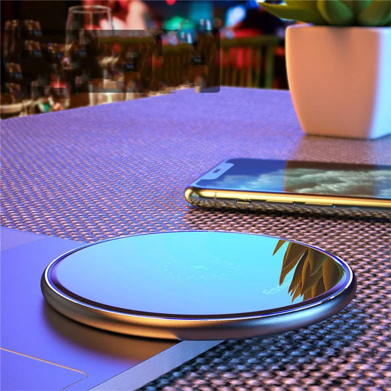 Black or white aluminium alloy wireless charging pad with LED status light, shown with a smartphone on top.