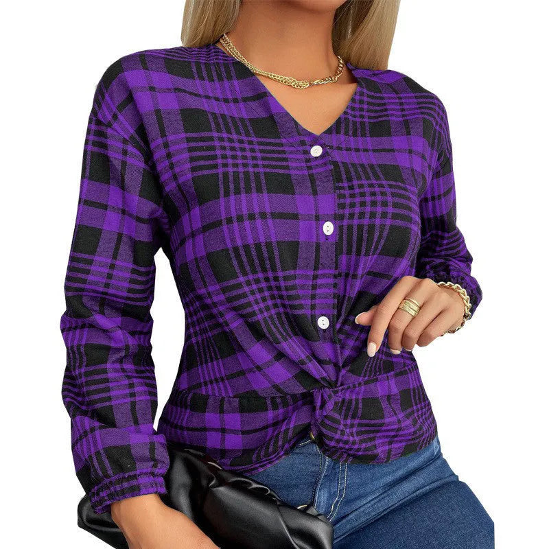 Woman wearing a loose-fitting purple plaid casual shirt with regular sleeves.