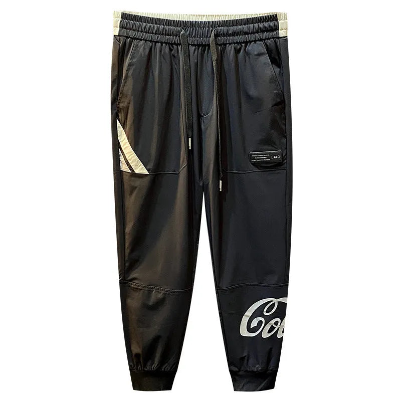 Men's black cropped ankle band trousers in ultra-thin ice silk cotton material showing casual styling