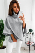 Women's long black batwing sleeve cardigan sweatshirt with three buttons and stitching detail.