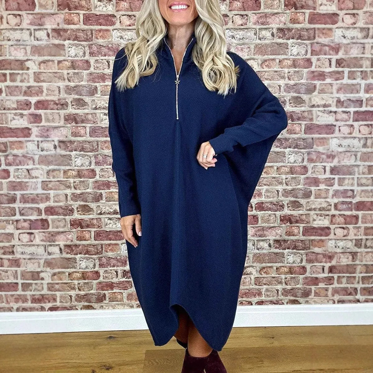 Women's solid colour loose knitted dress with raglan sleeves and a front zipper.