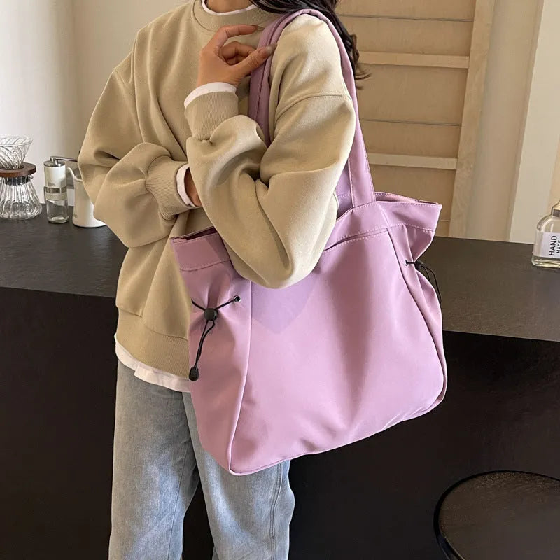 Oxford cloth shoulder tote bag in folding design showing soft construction and shoulder strap