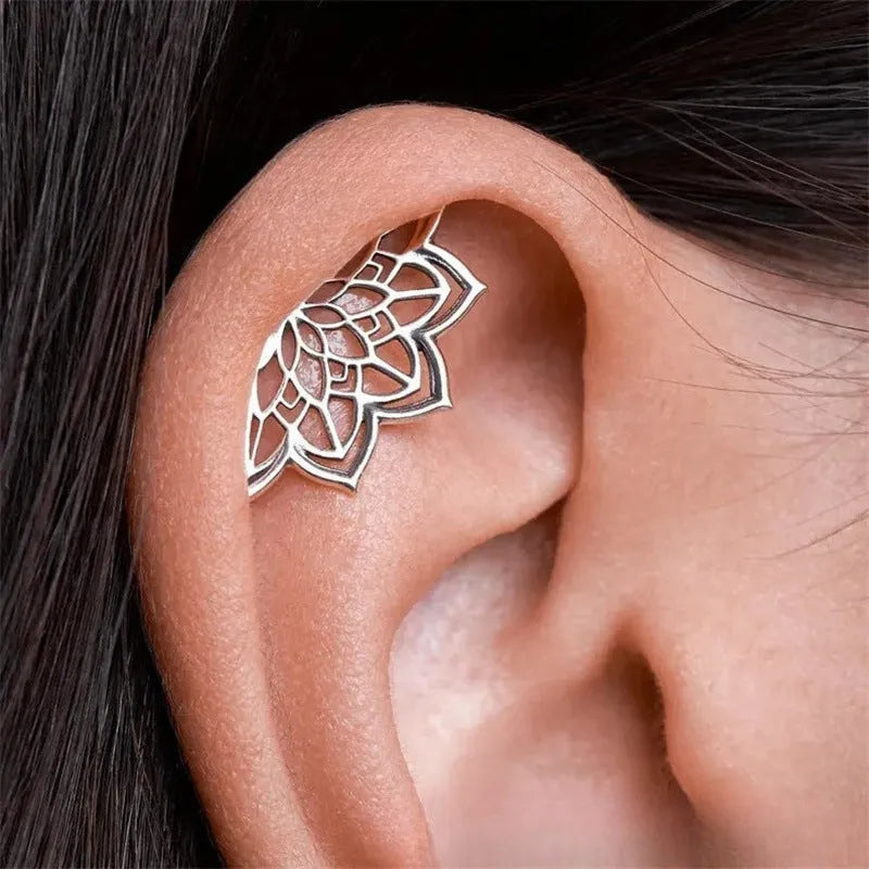 Gold and silver spider web stud earrings with geometric mesh pattern
