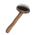 Wooden pet grooming set with comb, rake comb, and nail clippers in storage bucket