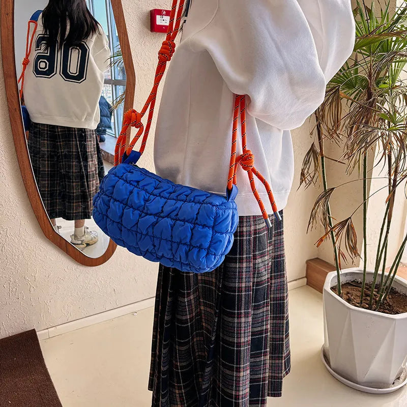 Women's soft nylon pillow-shaped messenger bag with diamond quilting and a crossbody strap.