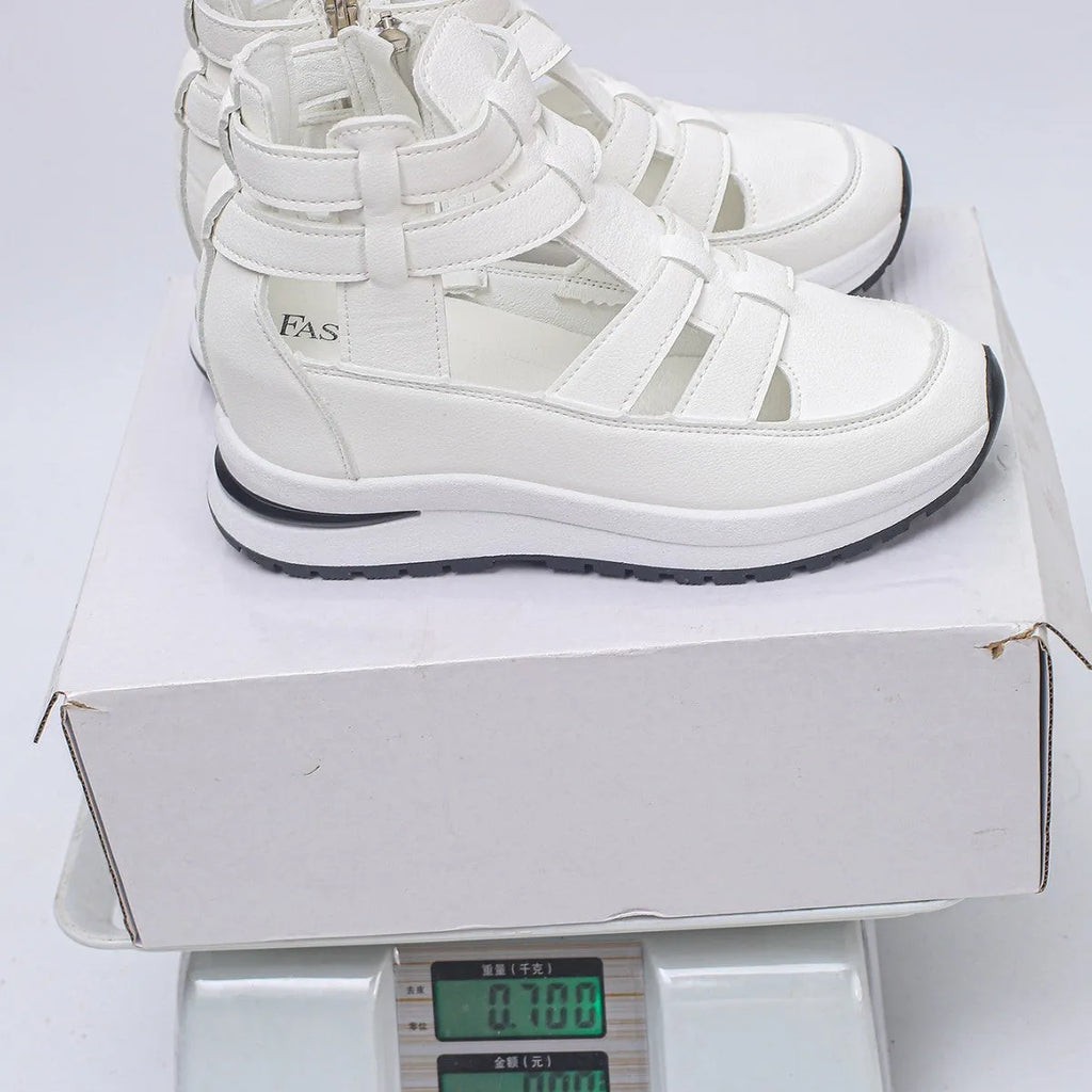 Women's black platform sandals with hollow-out design and Velcro strap.