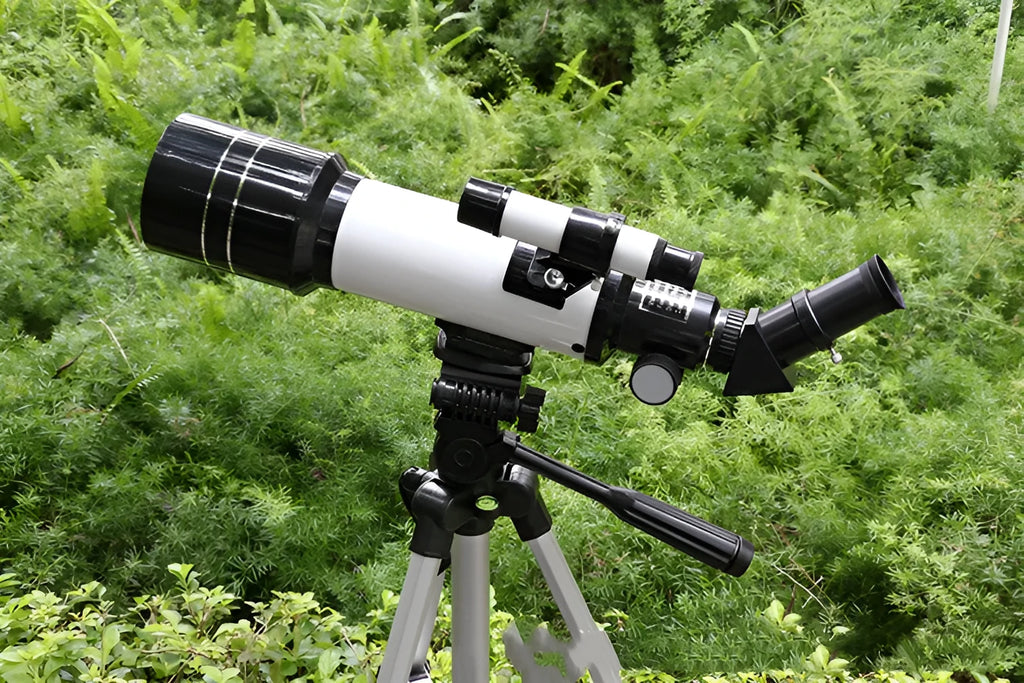 Children's dark blue astronomical telescope with tripod showing 16X-66X magnification specifications