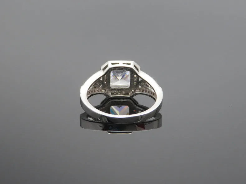 Geometric hollow design zircon ring in platinum-colour finish on copper, showing quadrilateral stone faceting