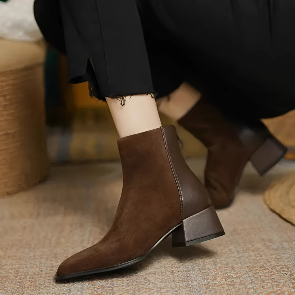 Women's suede martin boots in black with block heel and back zipper on a white background