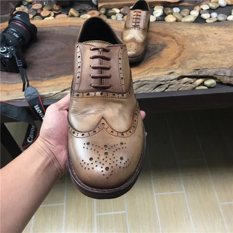 Men's light brown distressed leather shoes with vintage engraved detailing and round toe