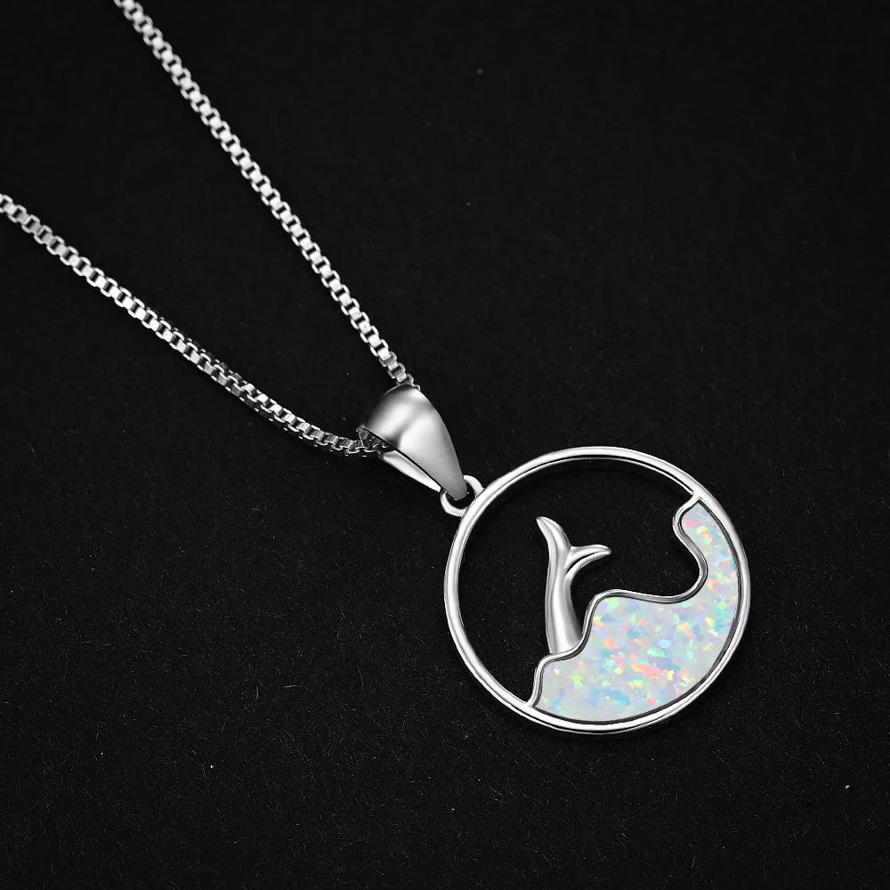 White gold electroplated geometric fishtail necklace pendant with a round blue opal stone.