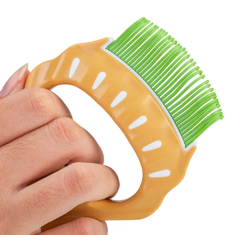 Green shell-shaped pet grooming comb with bent wire bristles and a plastic handle.