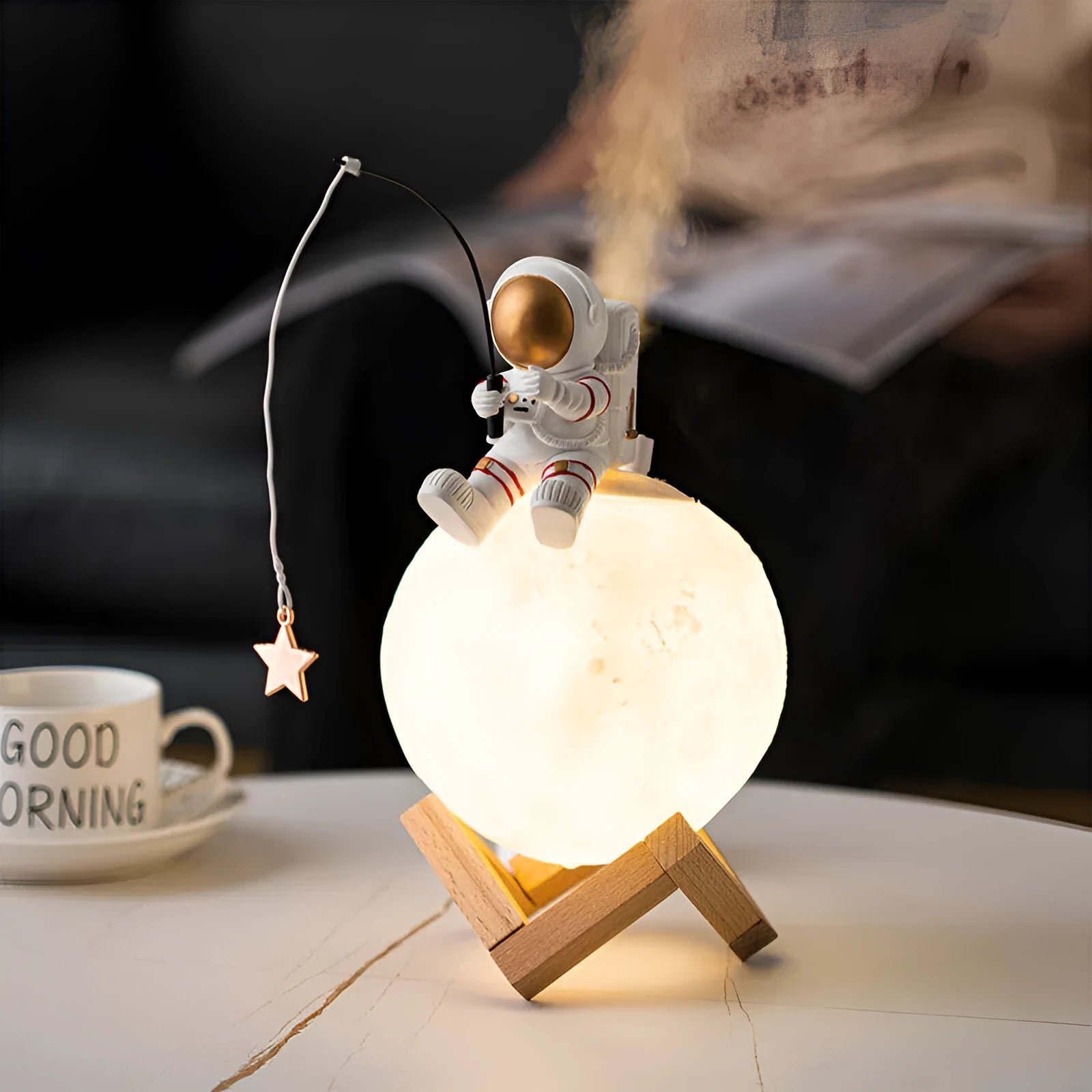 Gold resin astronaut figurine humidifier night light with wood base, 28 cm tall, on a desk