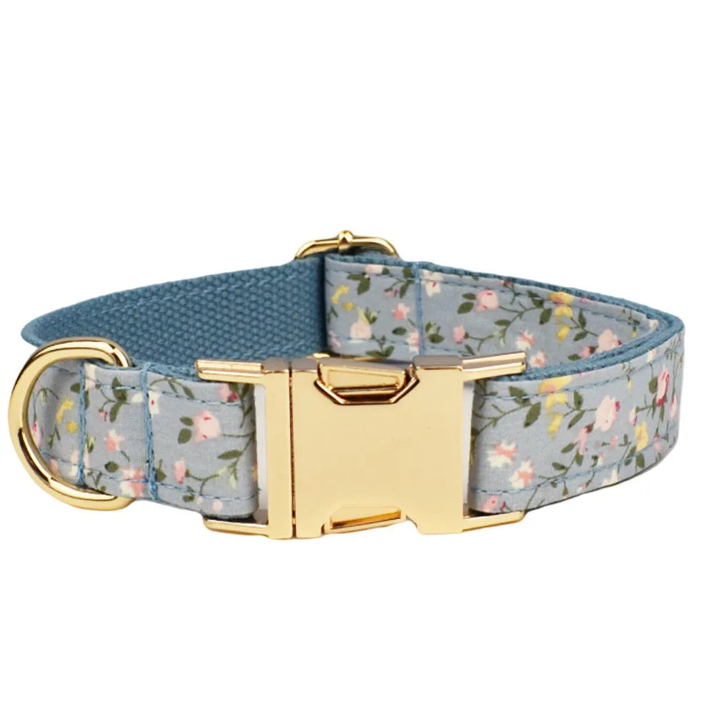 Blue floral polyester cotton dog collar set with matching leash, vest, poop bag, and decorative bow