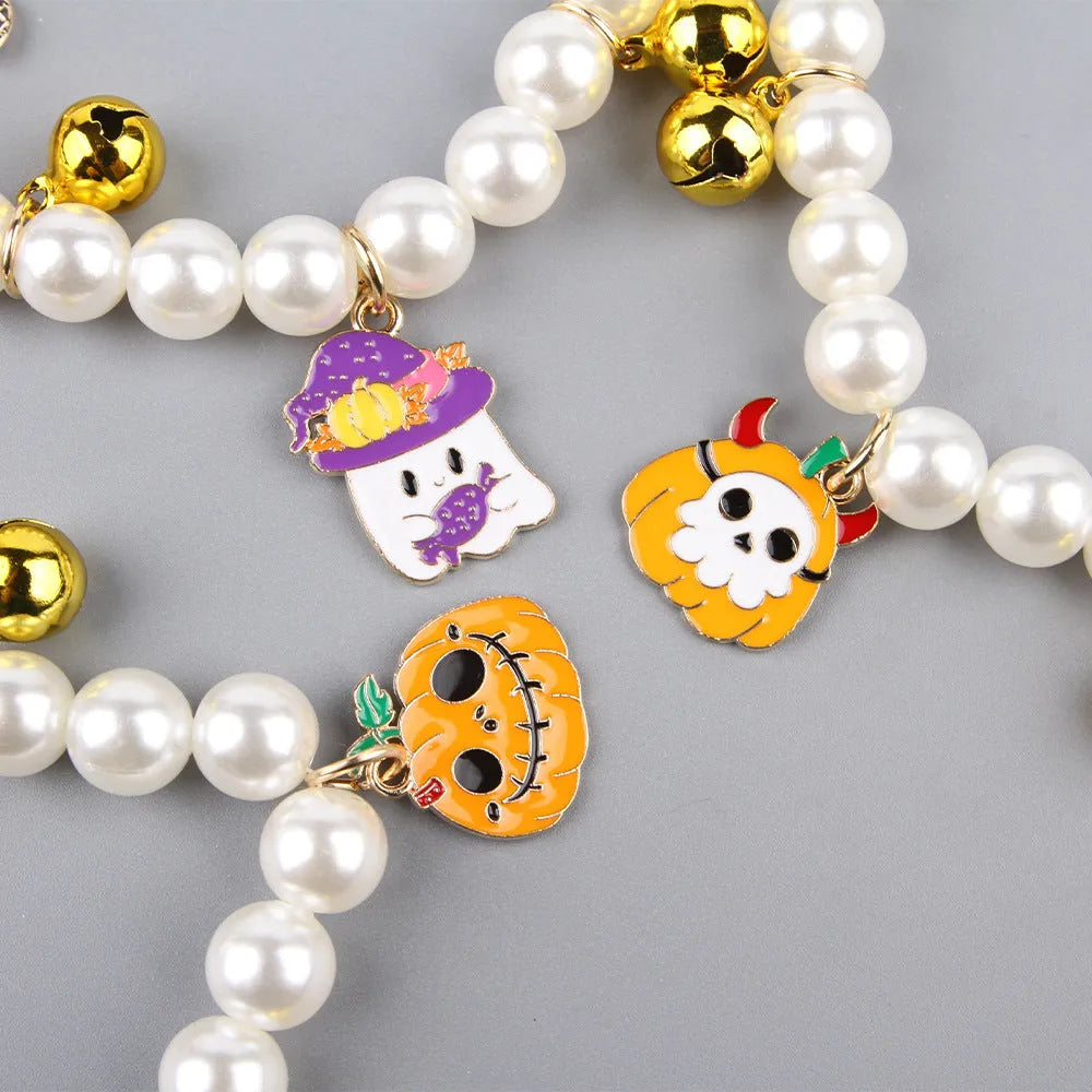 Halloween cat collar with simulated pearls and pumpkin designs including purple ghost, skull, and smiling pumpkin patterns