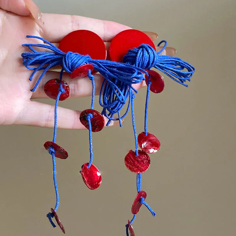 Women's handmade geometric cloth earrings with blue resin flower colour detail