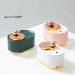 Green rotating planet humidifier with USB charging port and night light on wooden surface