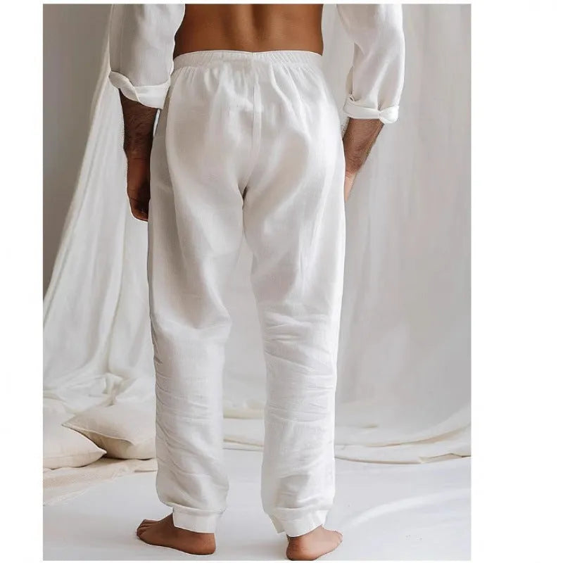 Men's loose-fit cotton linen trousers in light blue with an elastic drawstring waistband.