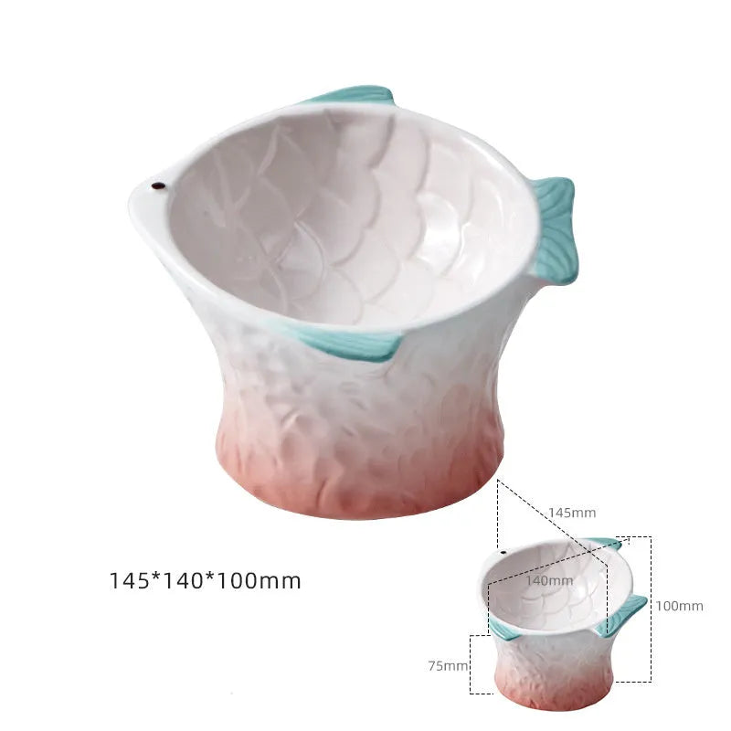 Blue fish-shaped ceramic cat bowl with 15-degree tilt angle on a wooden floor.