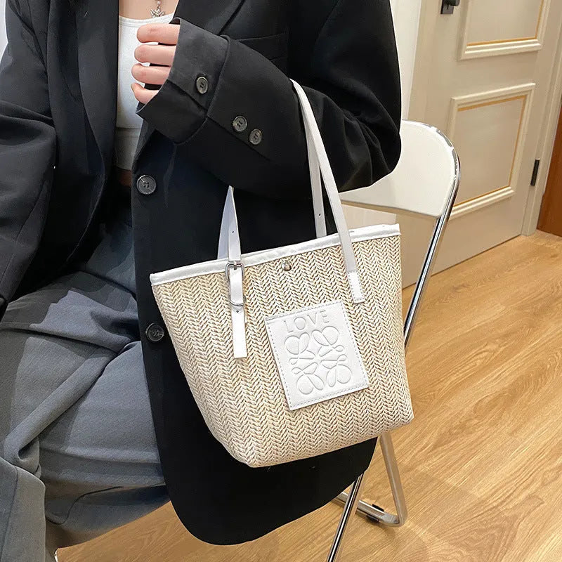 Straw woven women's shoulder bag with retro design showing three-dimensional pockets and 18cm handle