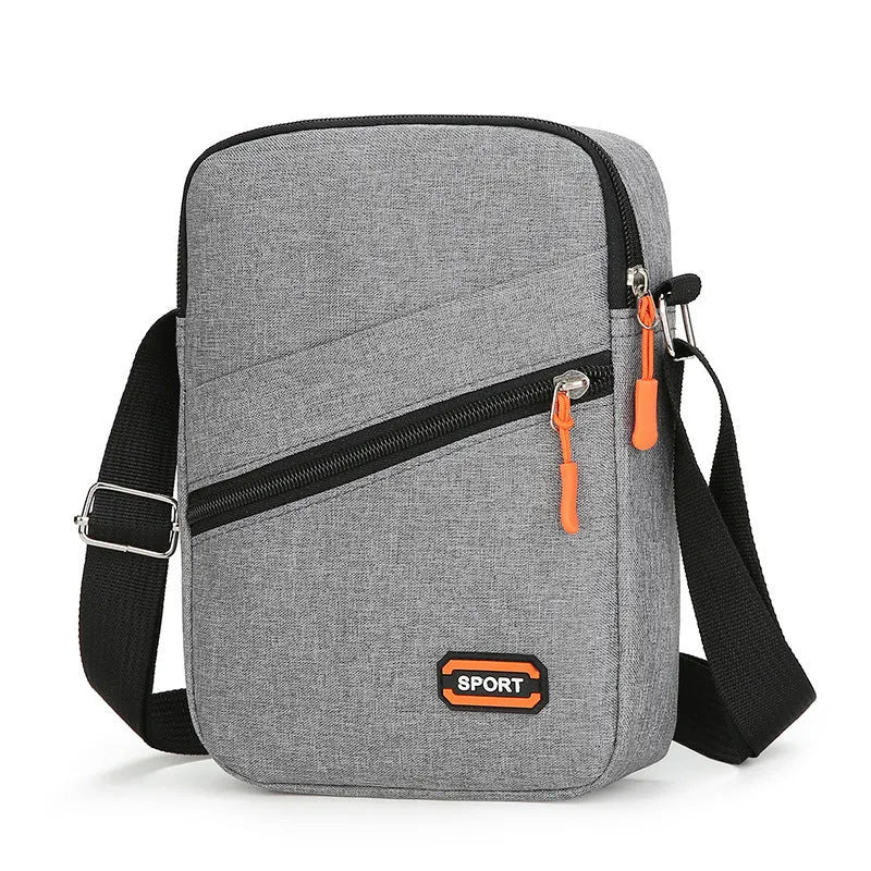 Lightweight Oxford cloth crossbody commuter bag in a solid colour with contrast detailing.