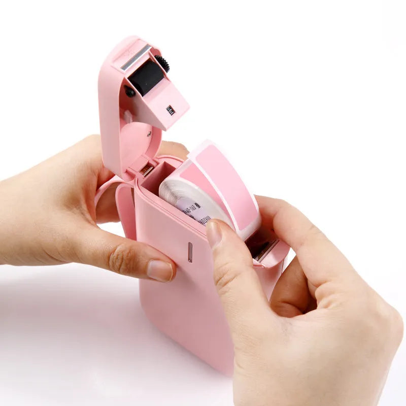 D11 Bluetooth thermal label printer in chosen colour next to smartphone showing label design app.