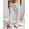 Men's loose-fit cotton linen trousers in light blue with an elastic drawstring waistband.
