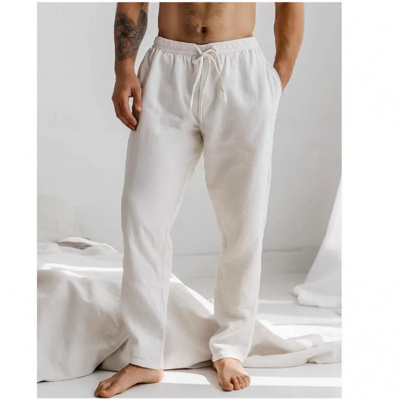 Men's loose-fit cotton linen trousers in light blue with an elastic drawstring waistband.