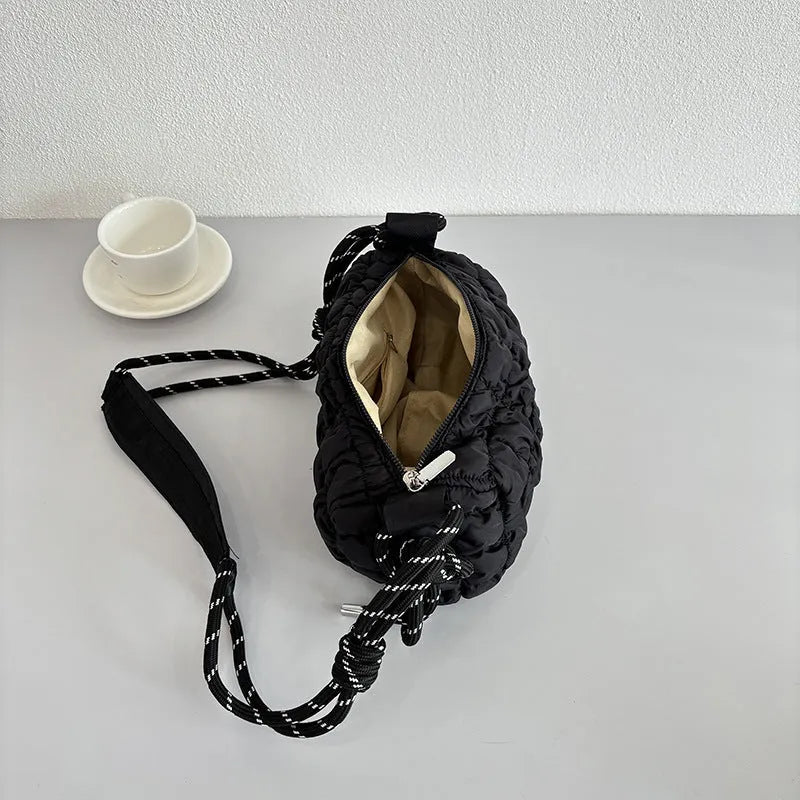 Women's soft nylon pillow-shaped messenger bag with diamond quilting and a crossbody strap.