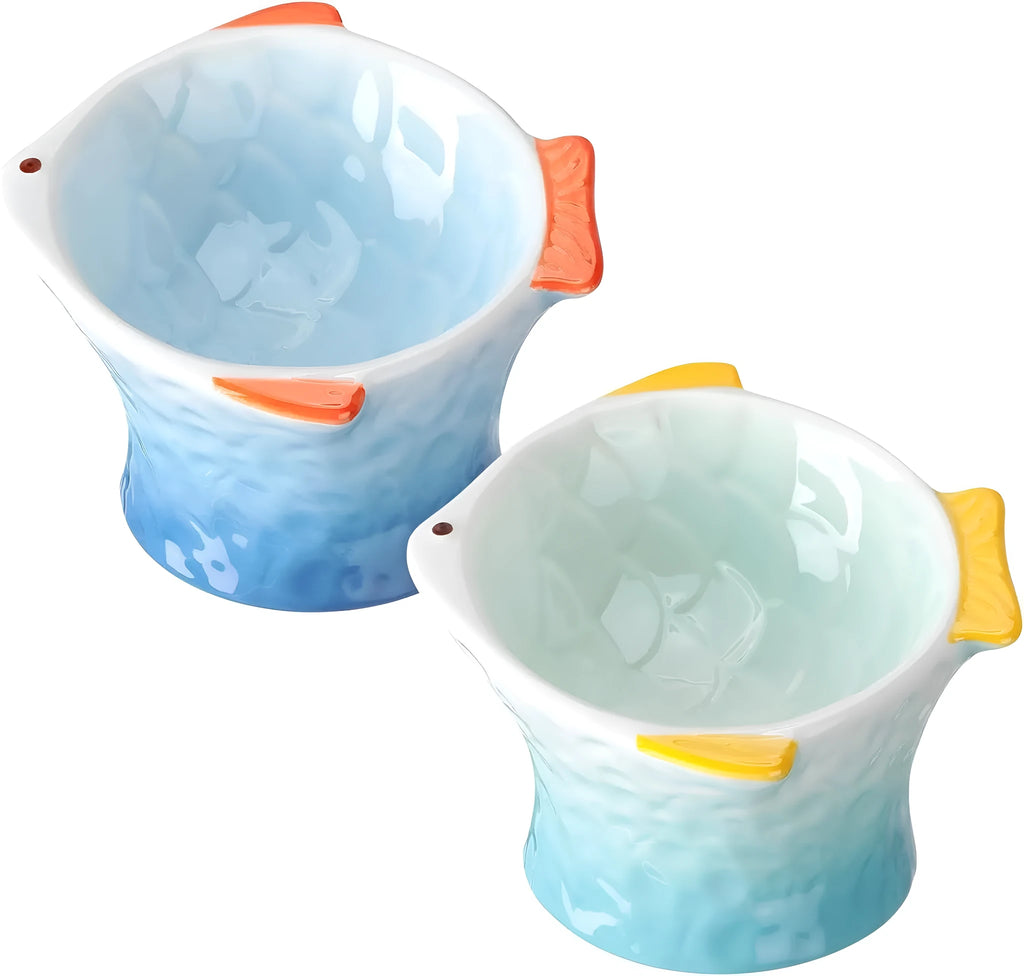 Blue fish-shaped ceramic cat bowl with 15-degree tilt angle on a wooden floor.