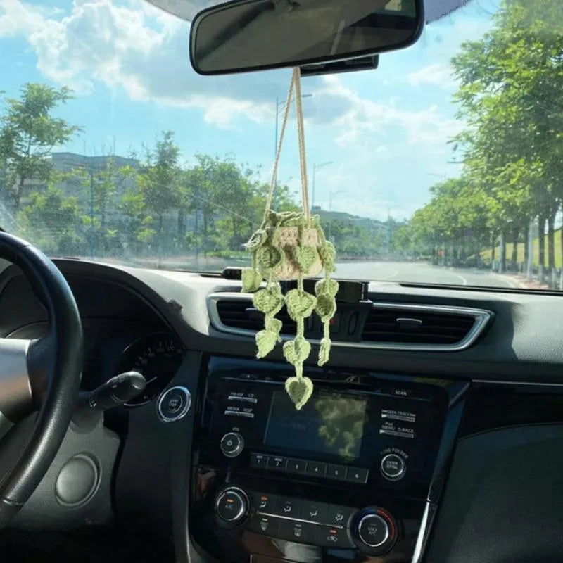 Green and white crochet knitted car plant decoration with rattan basin and white rope.