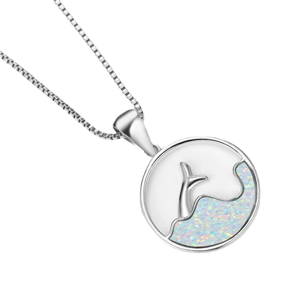 White gold electroplated geometric fishtail necklace pendant with a round blue opal stone.